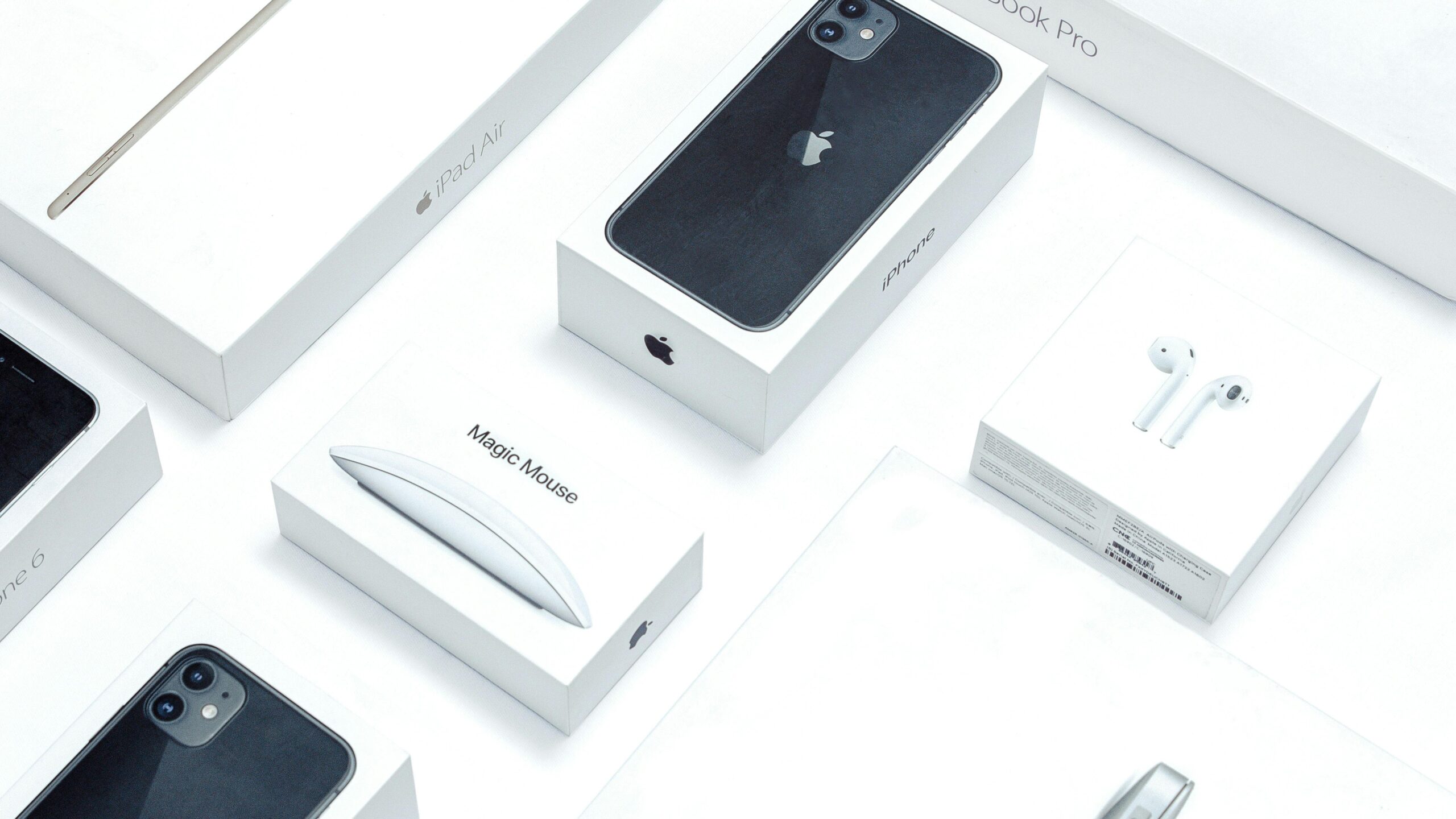 Flat lay of assorted Apple product boxes showcasing technology packaging design.